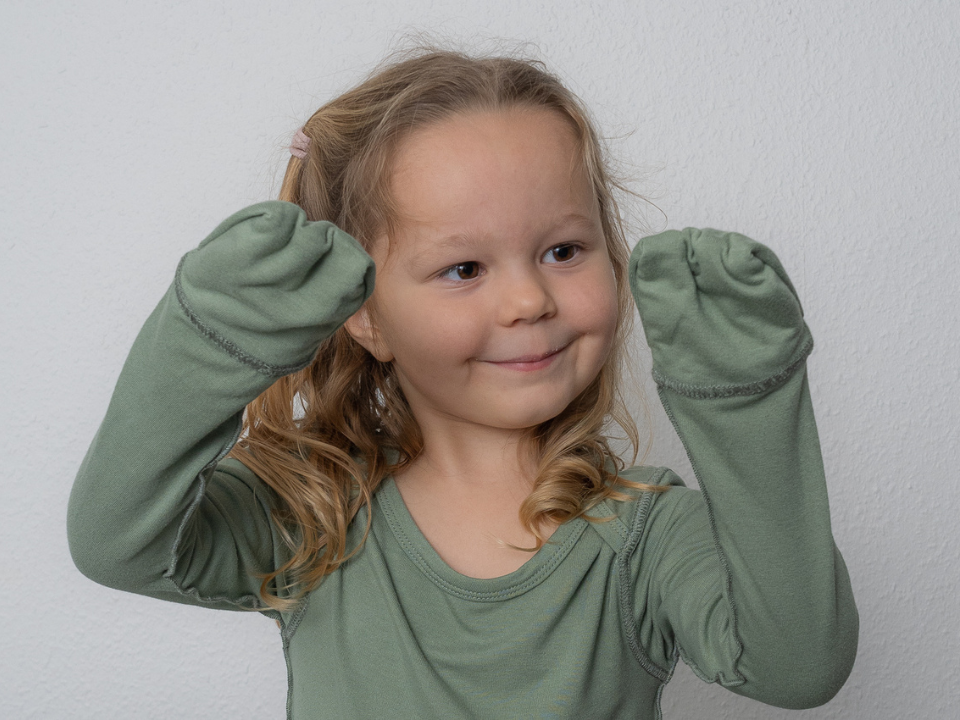 Girl Showing Off SOOTHLA Baby Bodysuit With Anti-scratch Mittens