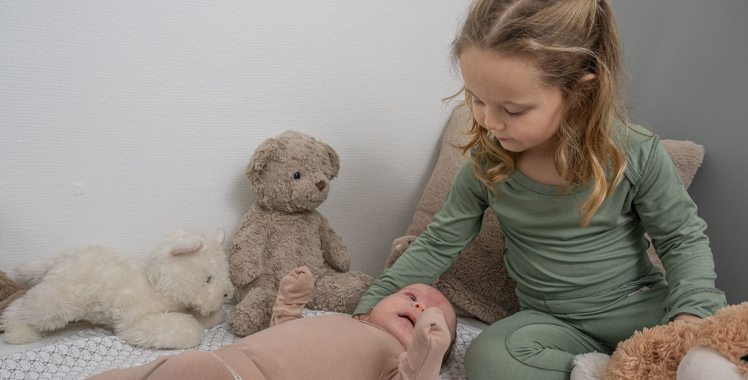 Baby And Toddler On Bed Wearing SOOTHLA Allergy-friendly Clothing