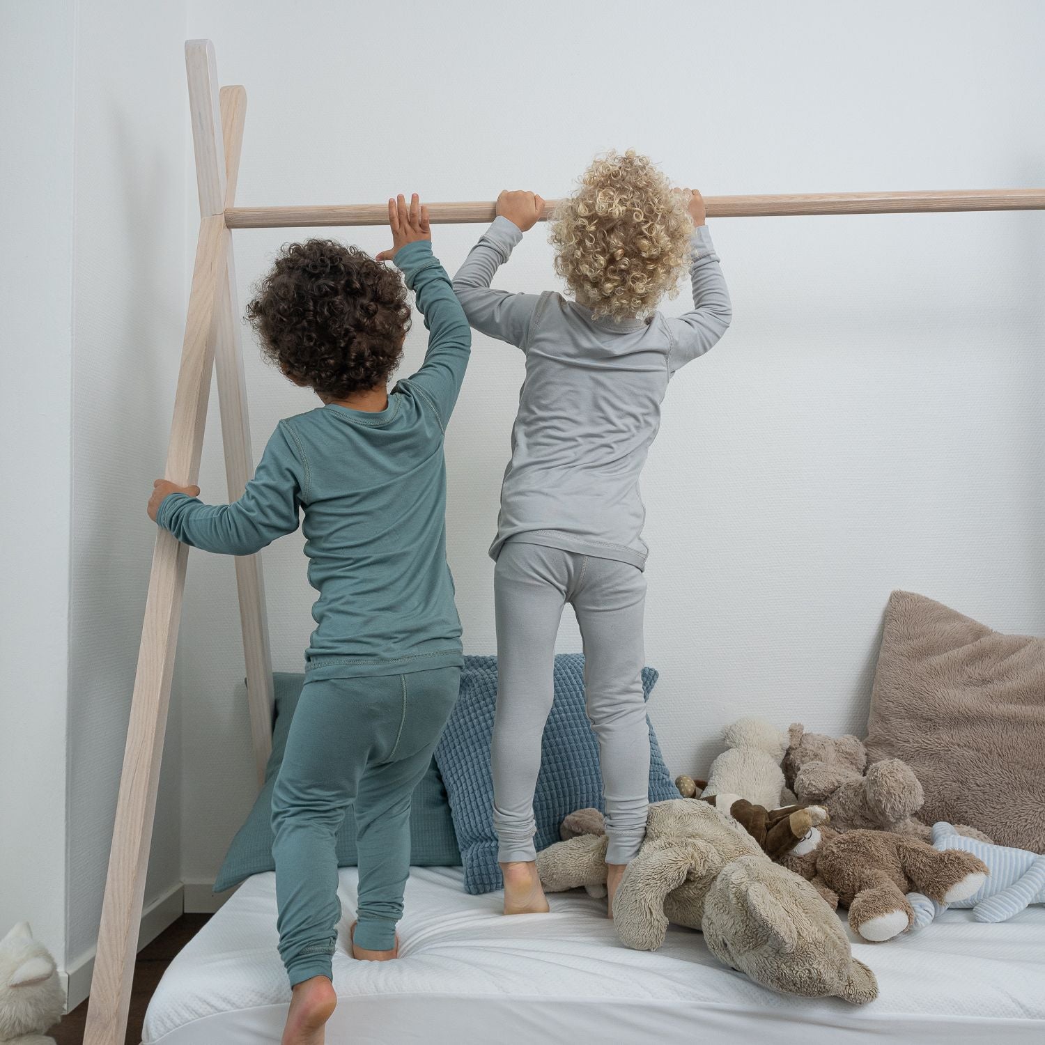Boys Wearing Allergy-friendly Clothing From SOOTHLA Playing On Toddler Bed