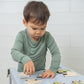 Little Boy Playing With Jigsaw Puzzle In SOOTHLA Allergy-friendly Clothing