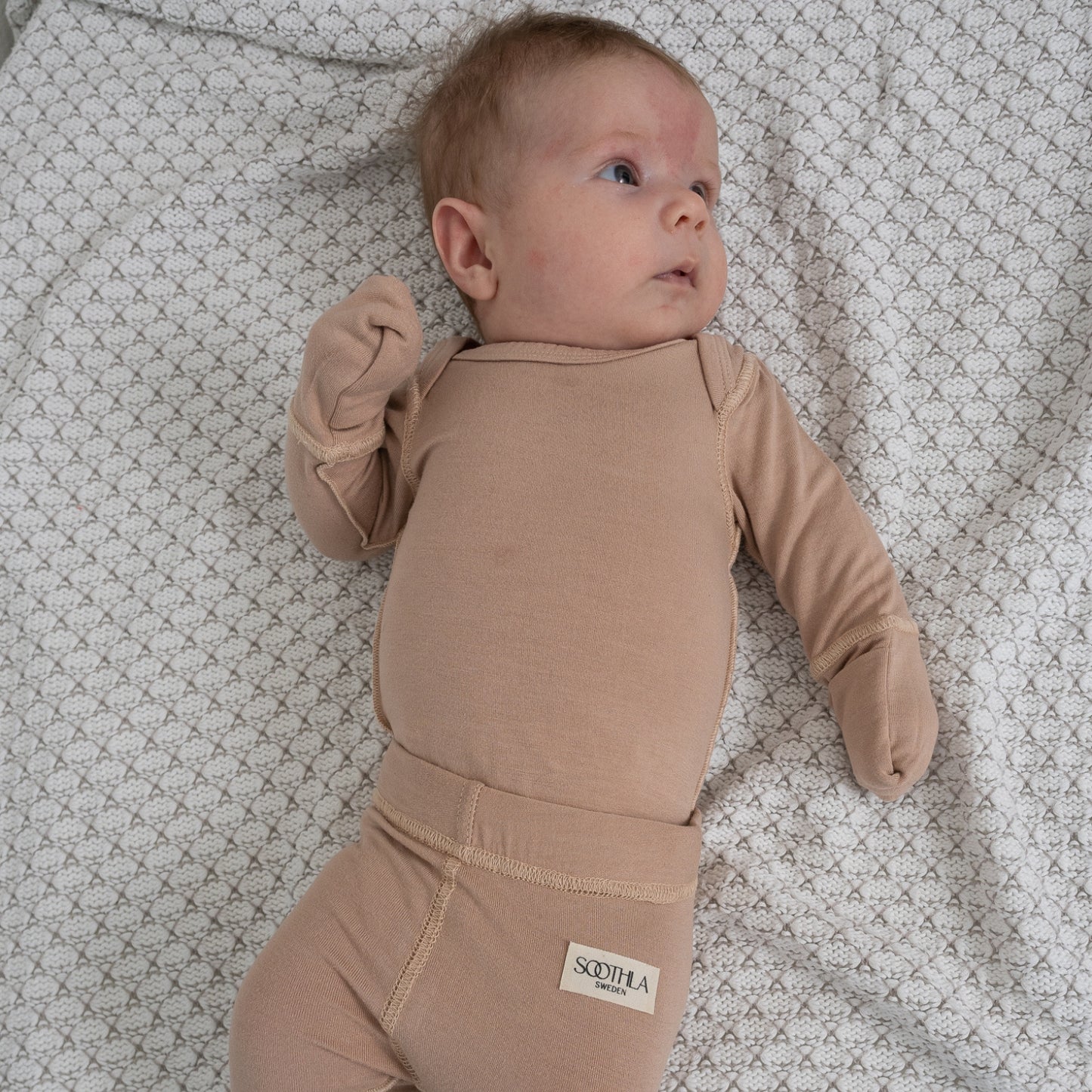 Baby With Eczema On Face Wearing Mahogany Rose Baby Bodysuit And Legging From SOOTHLA.