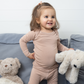 Girl In SOOTHLA Long-sleeved Baby Top And Legging Set.