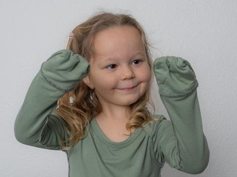 Toddler Wearing Allergy-friendly Baby Bodysuit With Anti-scratch Mittens From SOOTHLA.